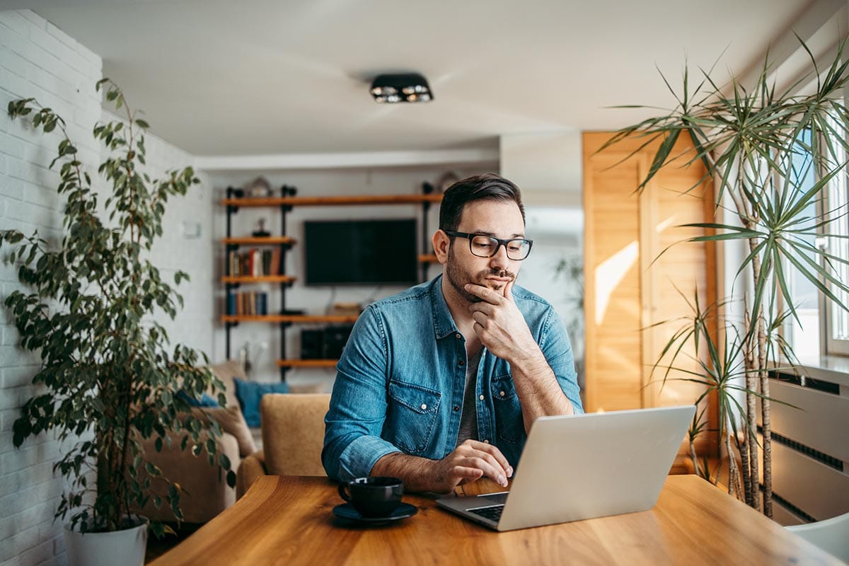 a man researches how to find drug treatment centers near me at home on his laptop for advice on choosing the best one for his needs