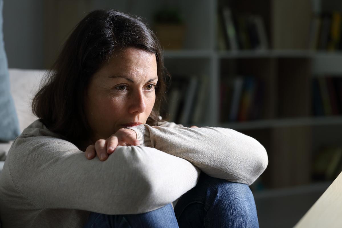 women looking off into distance in dark room