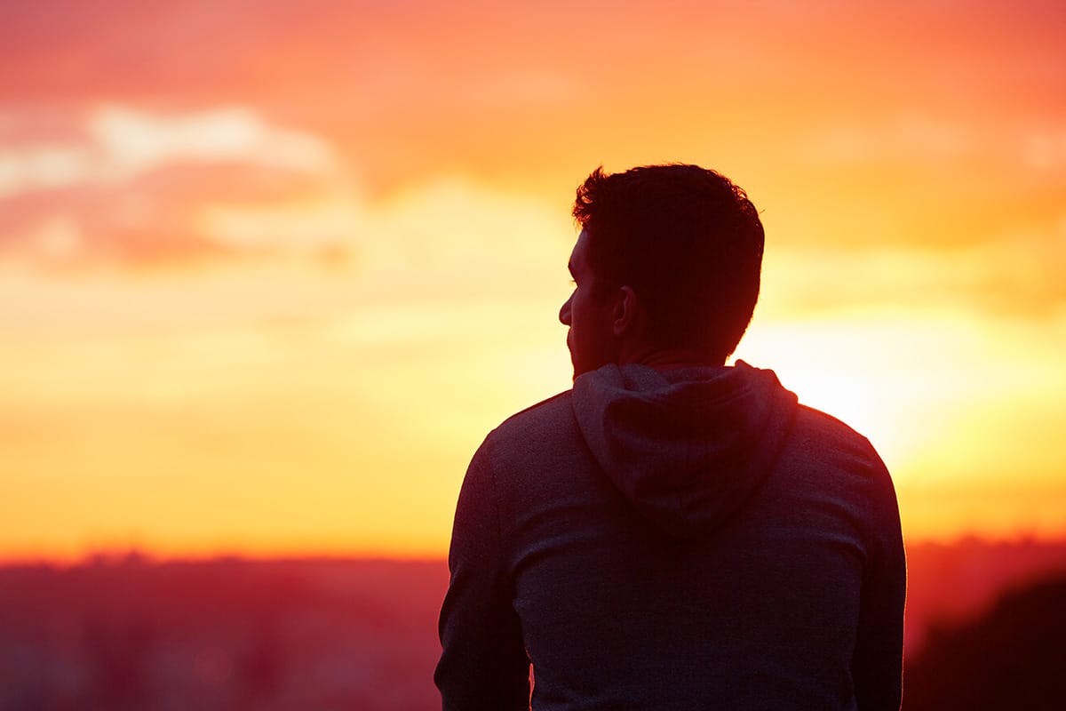 a man looks introspectively at a sunset in drug addiction treatment for cocaine and heroin speedball